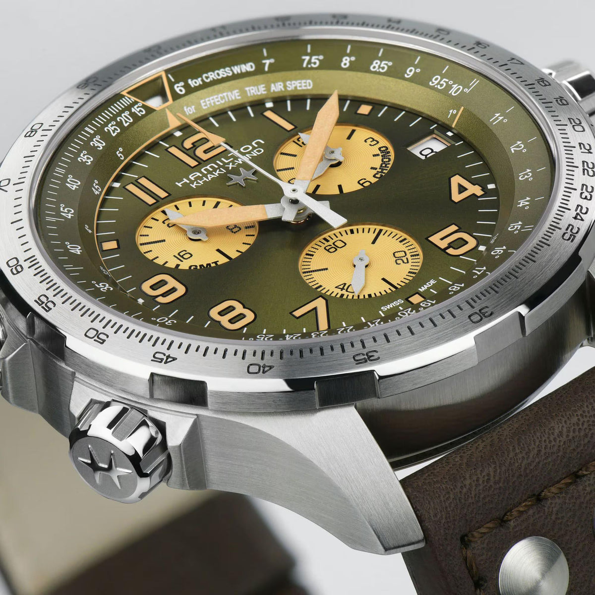 Aviation chronograph watch face with green dial, gold subdials, and textured silver bezel