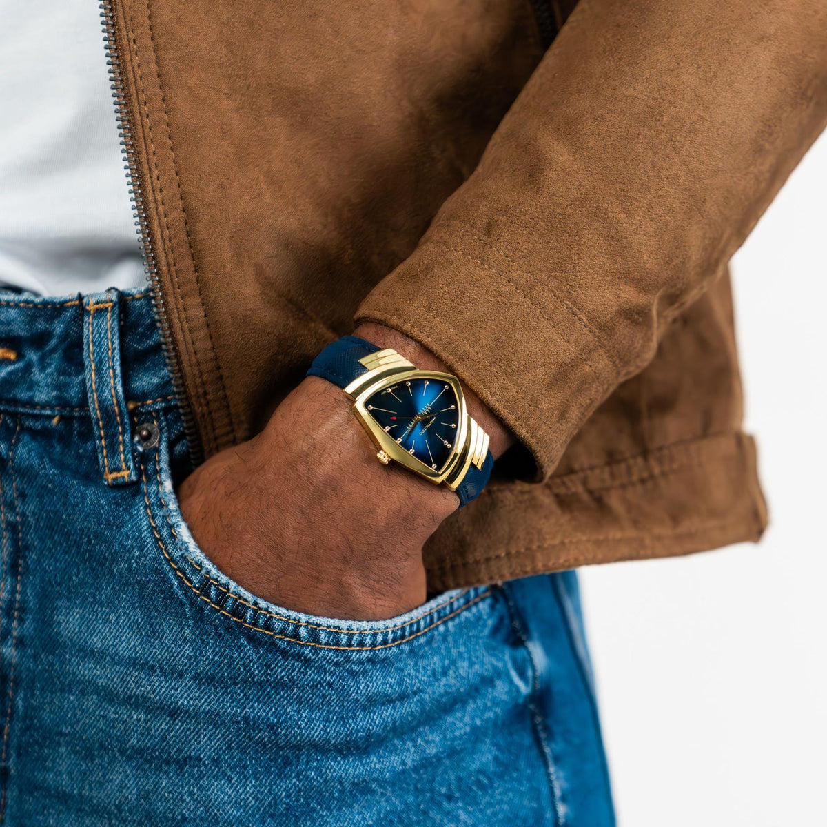 Ladies quartz watch on wrist with blue dial, gold-tone case, blue textile strap