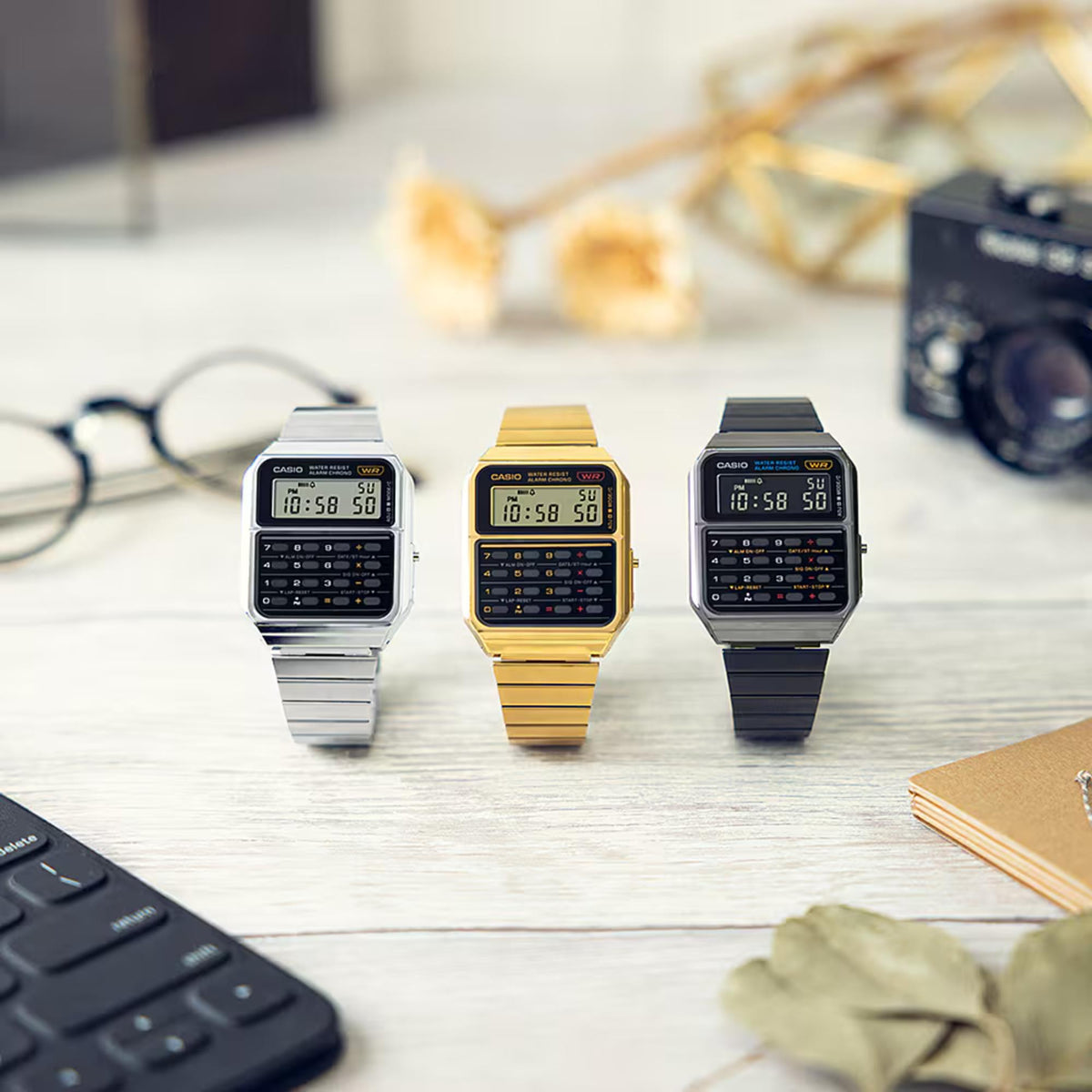 Casio calculator-style digital watches with silver, gold, and dark metal bracelets
