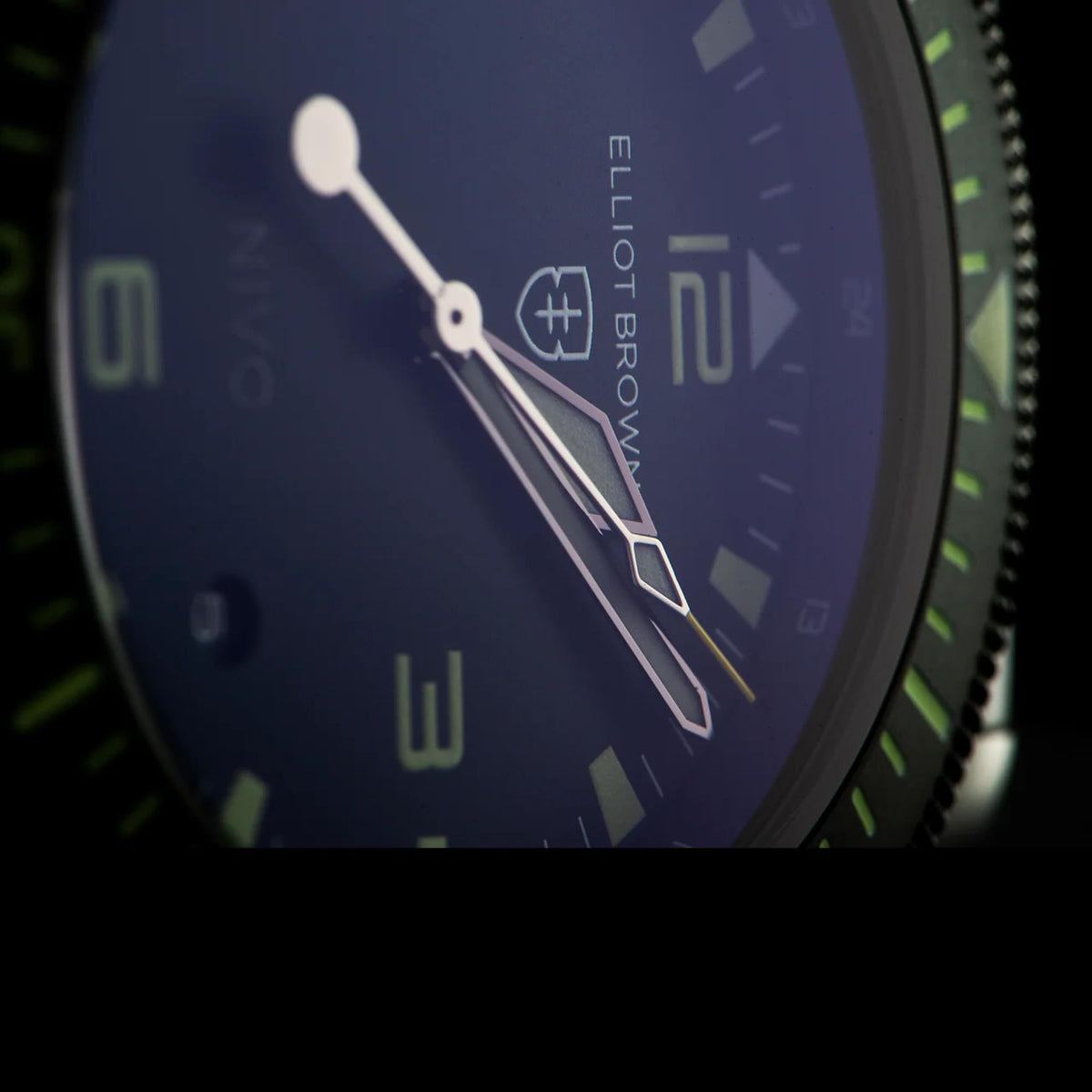 Men's quartz watch dial close-up with blue face, luminous hands, and hour markers