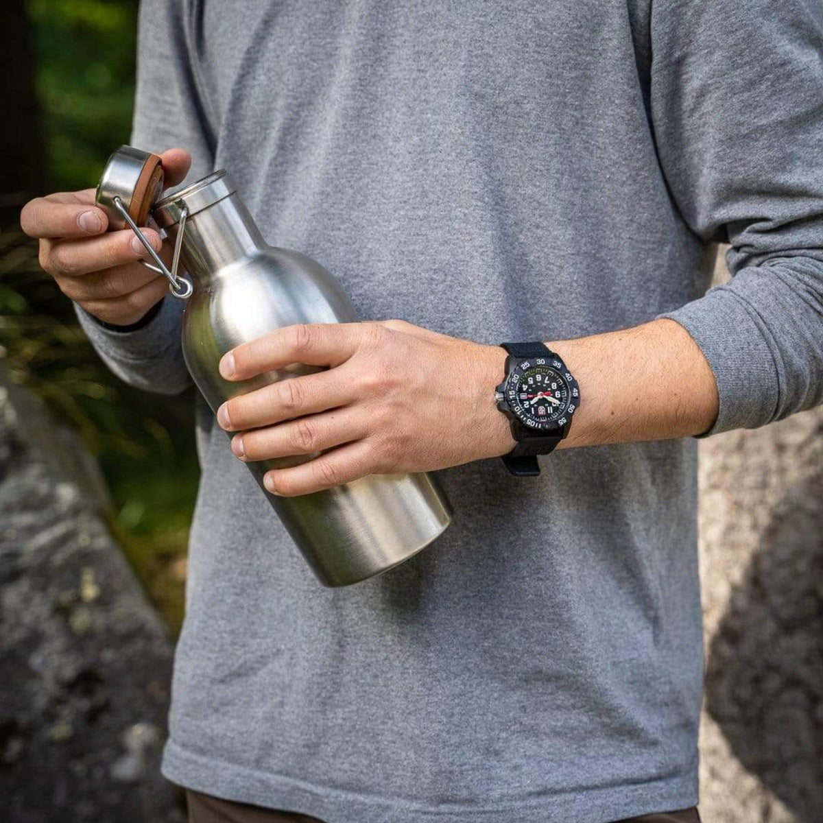 Luminox Navy SEAL 3500 Series XS.3501.F lifestyle view of watch worn on wrist holding stainless steel bottle