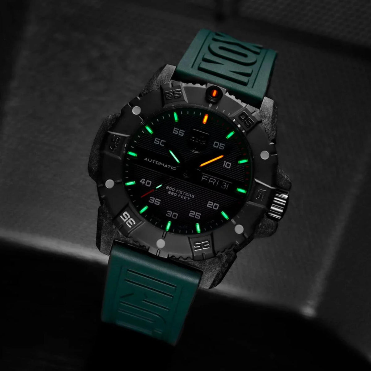 Men's automatic dive watch with black dial and green rubber strap, angled view