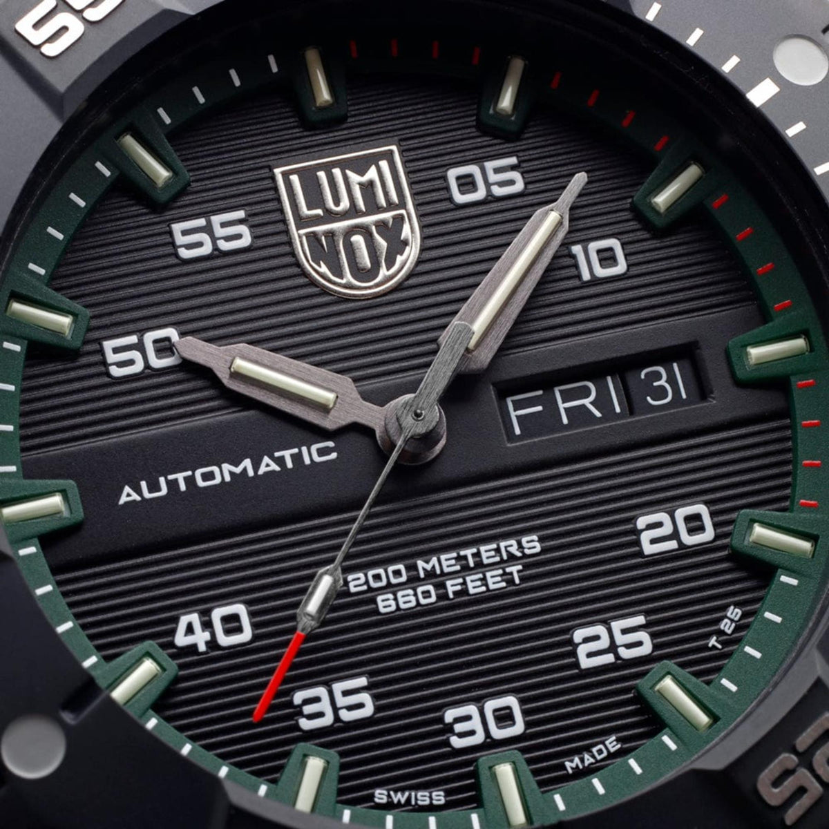 Close-up of men’s automatic dive watch dial with LUMI Nox logo and green hour markers