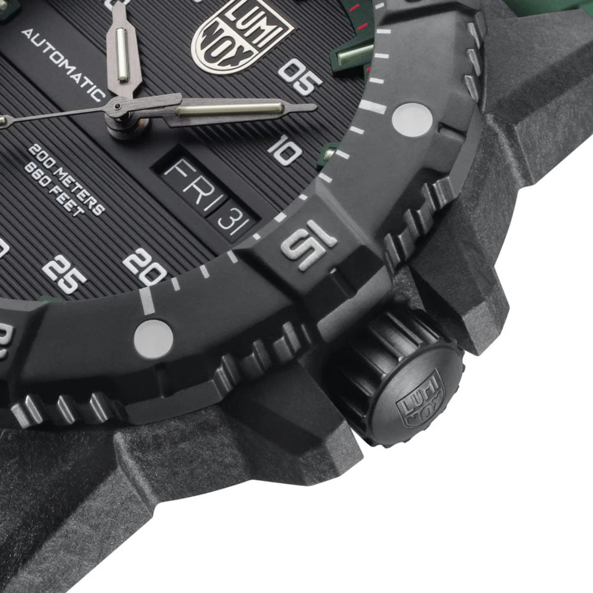 Close-up of men’s automatic dive watch case and dial with green markers and knurled crown