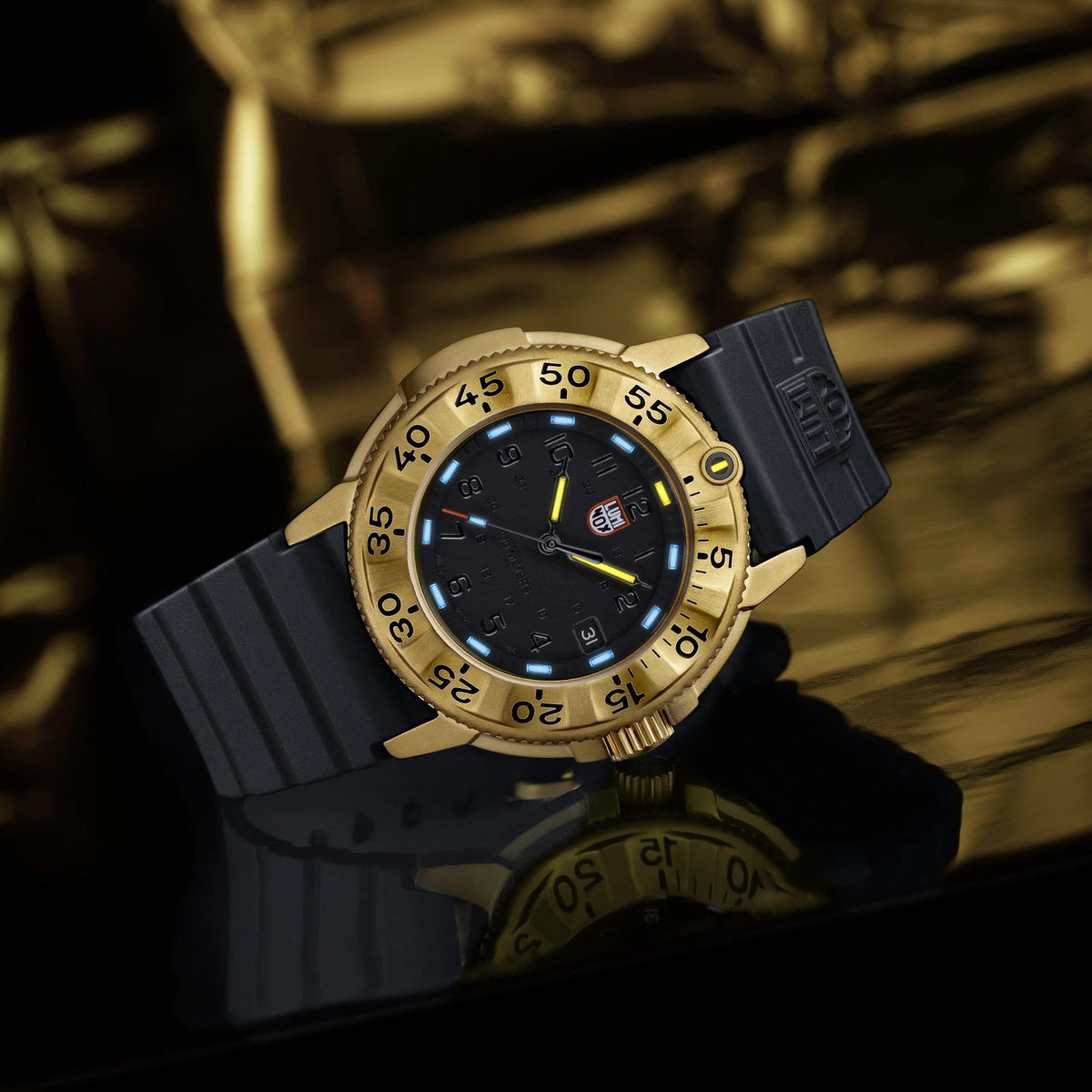Men's Luminox quartz watch with gold bezel, black dial, and black rubber strap