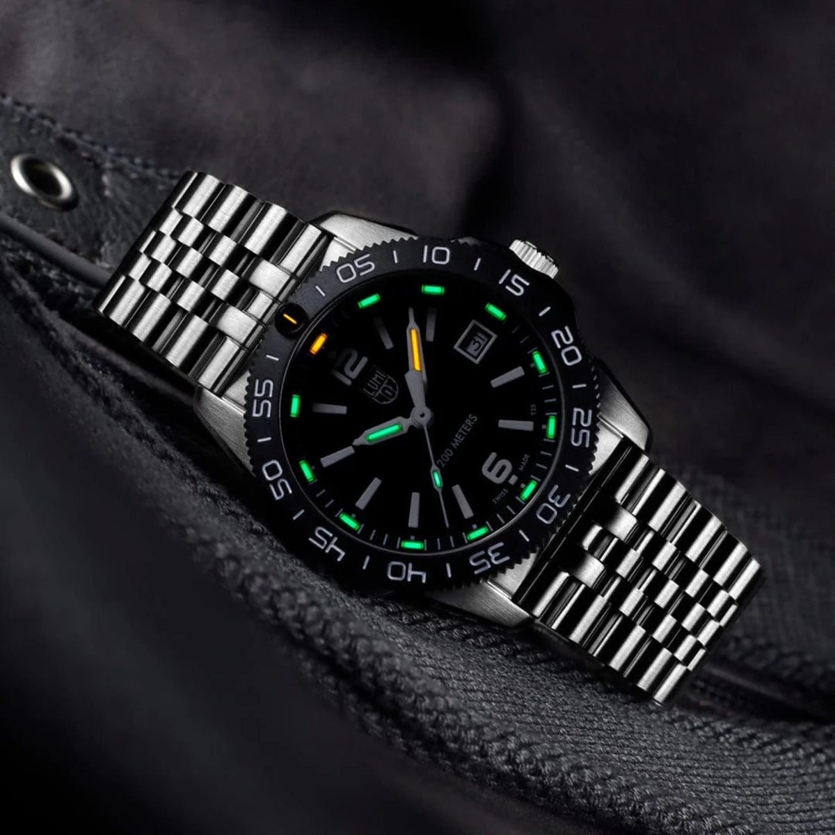 Luminox Pacific Diver XS.3122M low light view of illuminated hands and indices against black dial surface