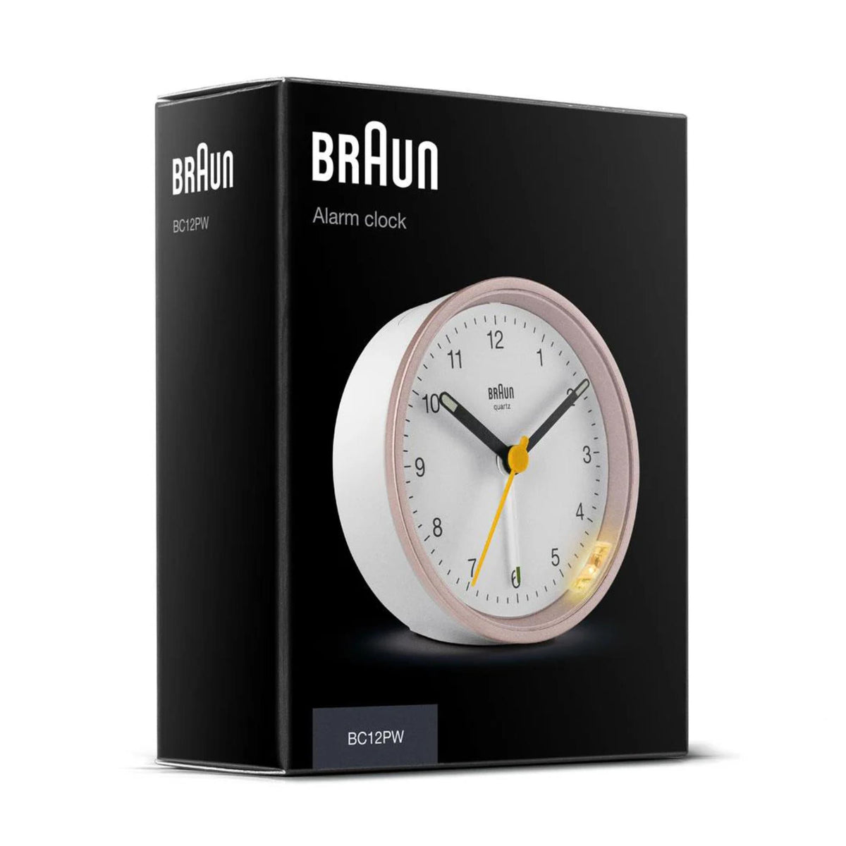 Braun quartz alarm clock shown in retail packaging with white dial and yellow second hand