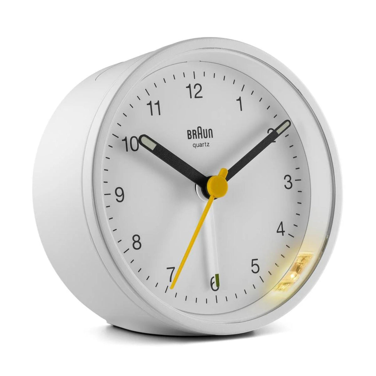 White round Braun quartz alarm clock, black dial with yellow hands, green indicator