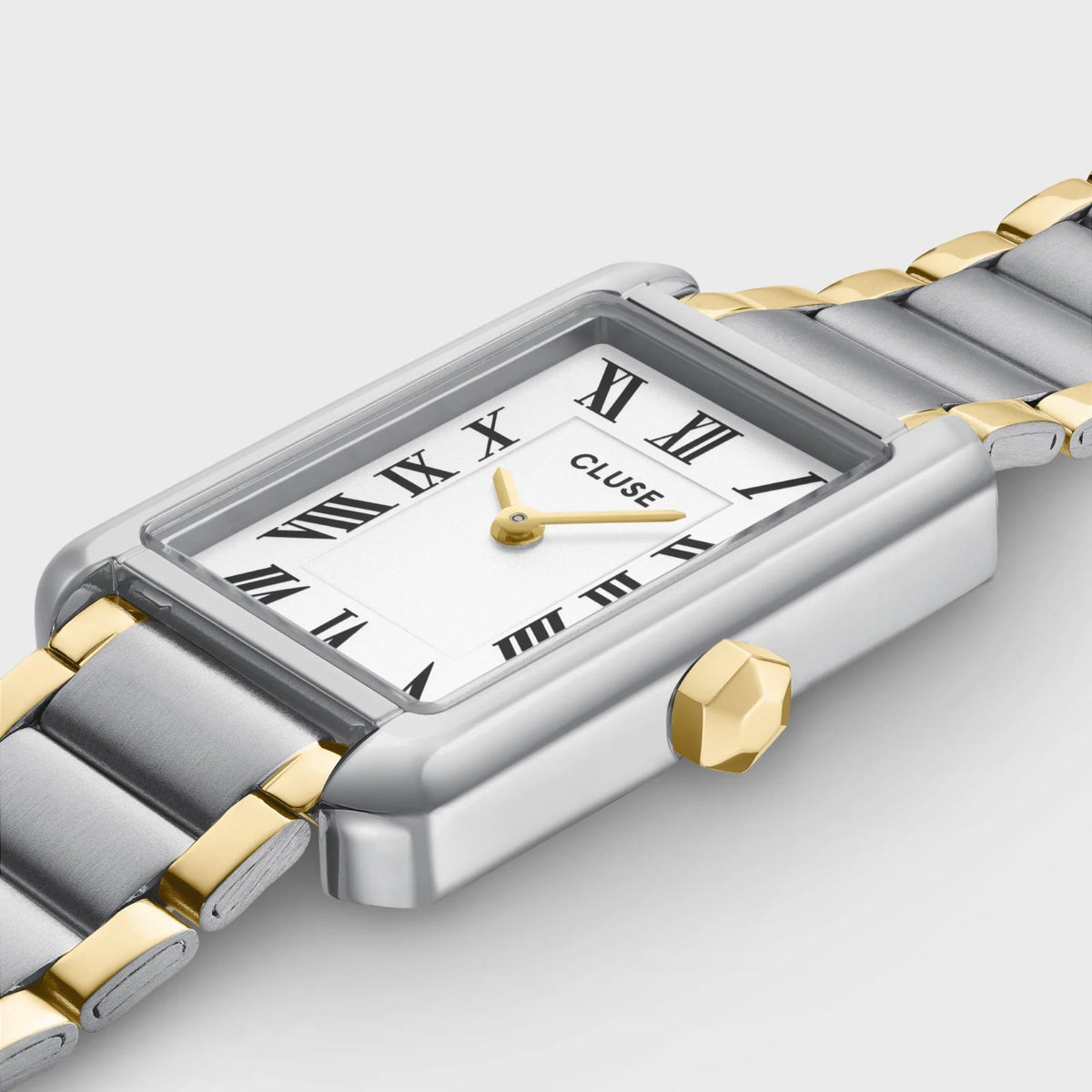 Two-tone steel watch with white dial and Roman numerals in rectangular case, close-up
