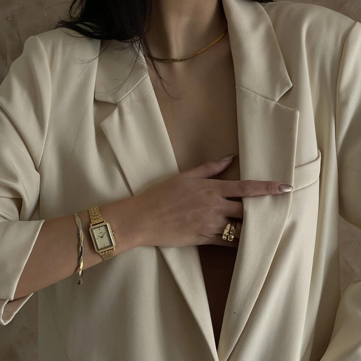 Gold-tone women’s square wristwatch with textured light dial and metal link bracelet