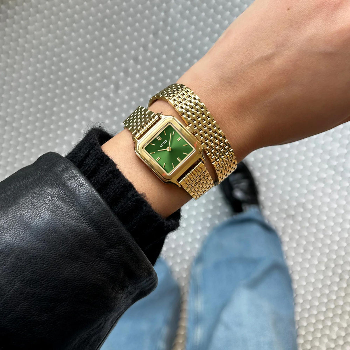 CLUSE petite watch on wrist with green dial and gold-tone mesh bracelet