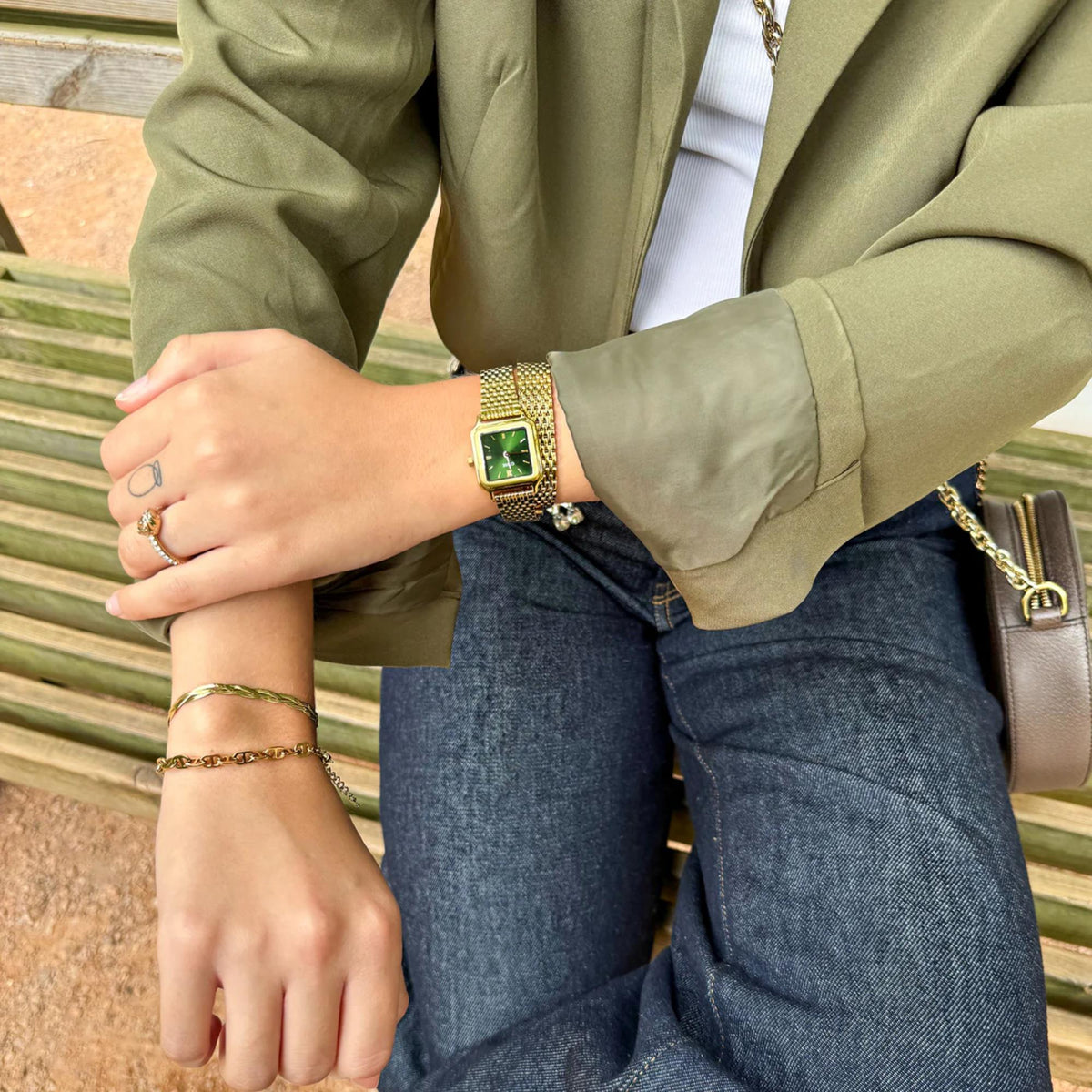CLUSE petite watch on wrist with green dial and gold-tone mesh bracelet