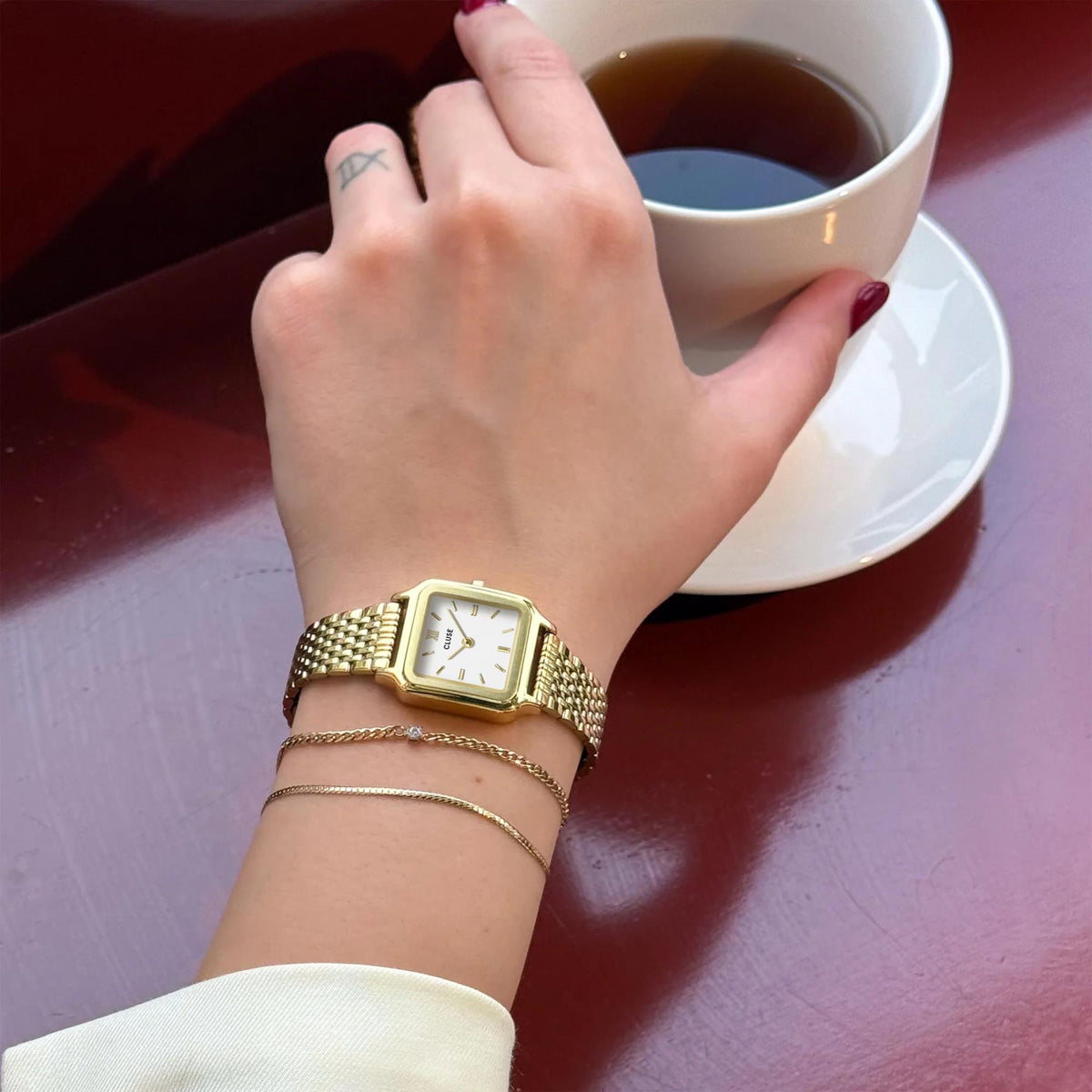 CLUSE women’s square quartz watch with gold-tone mesh band and white dial