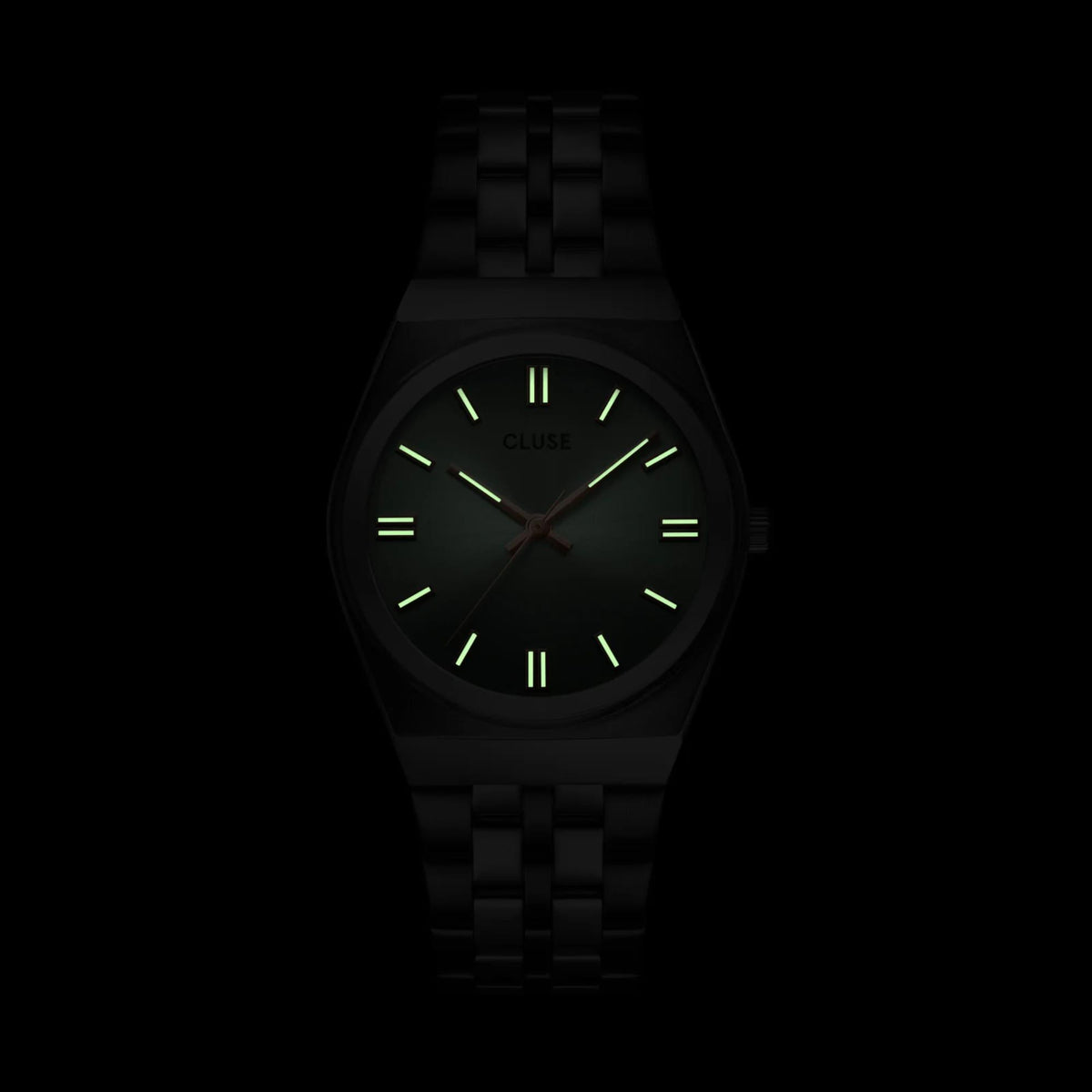 Dark stainless steel wristwatch with glowing green dial markers and slim hands