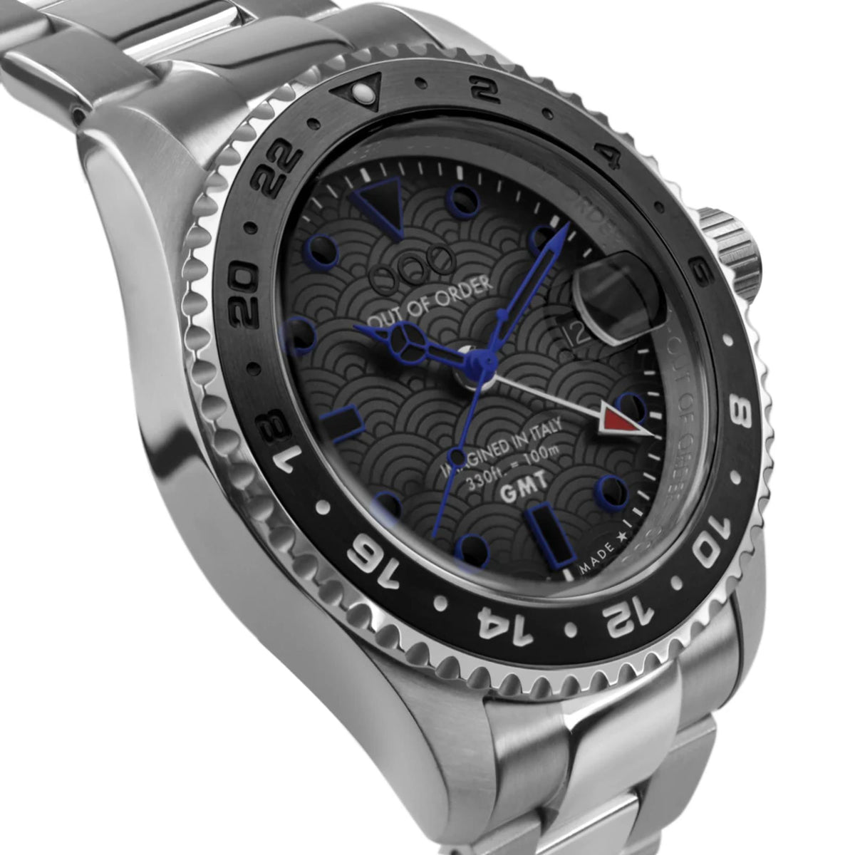 Stainless steel GMT watch with black bezel and blue patterned dial, close-up