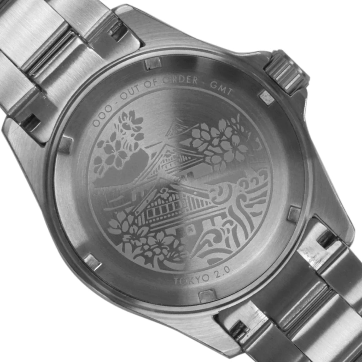 Stainless steel caseback of a GMT watch with engraved Tokyo design and markings