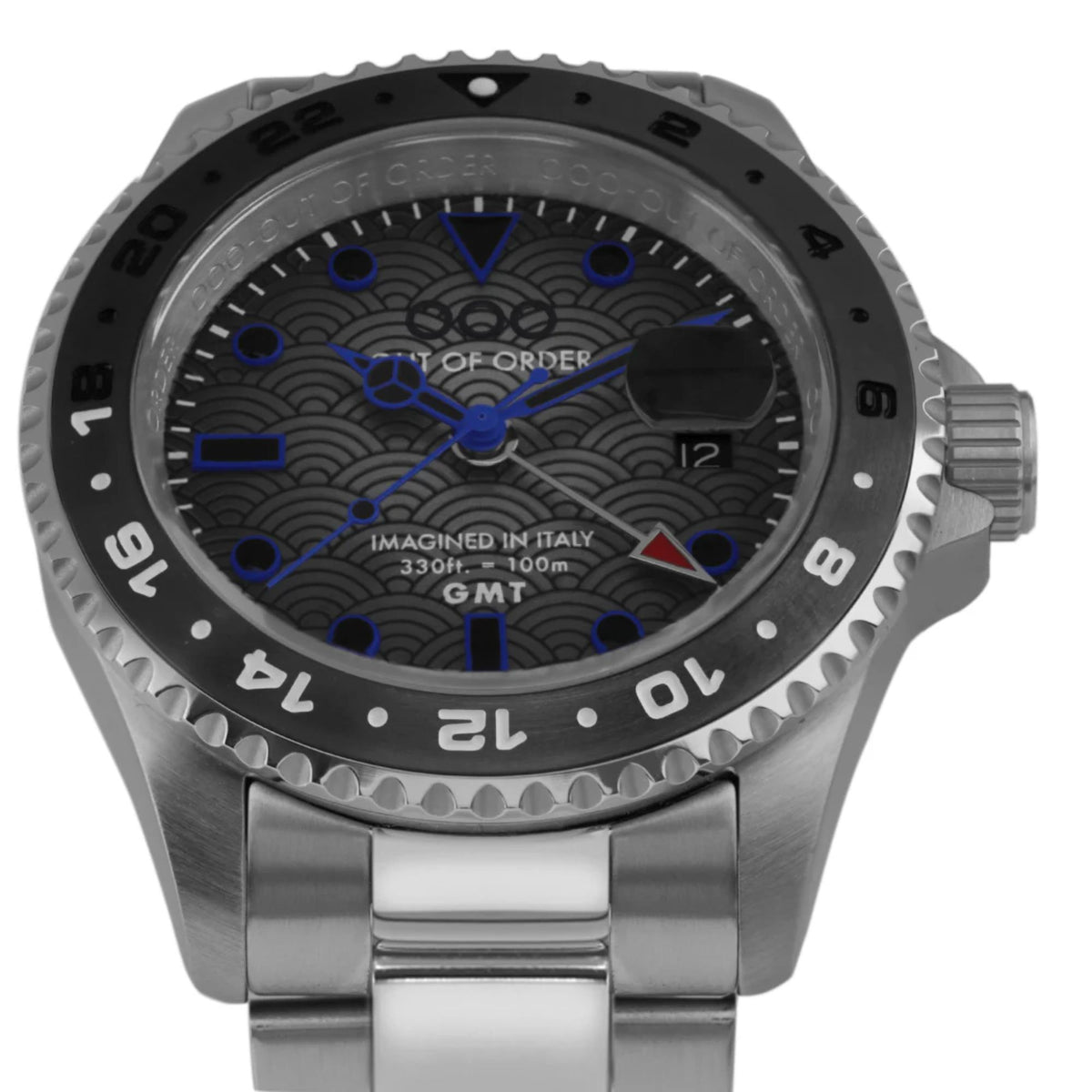 Stainless steel GMT watch with black bezel and blue-accent patterned dial, front view