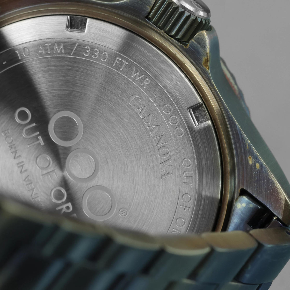 Men's watch stainless steel caseback with engraved markings and water-resistance text.