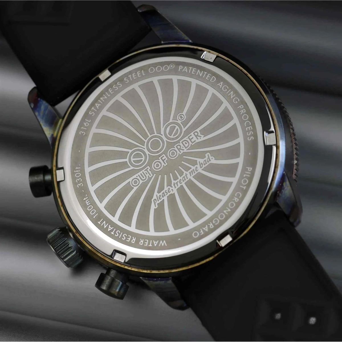 Men's watch case back with white radial engraving and gold-tone outer ring