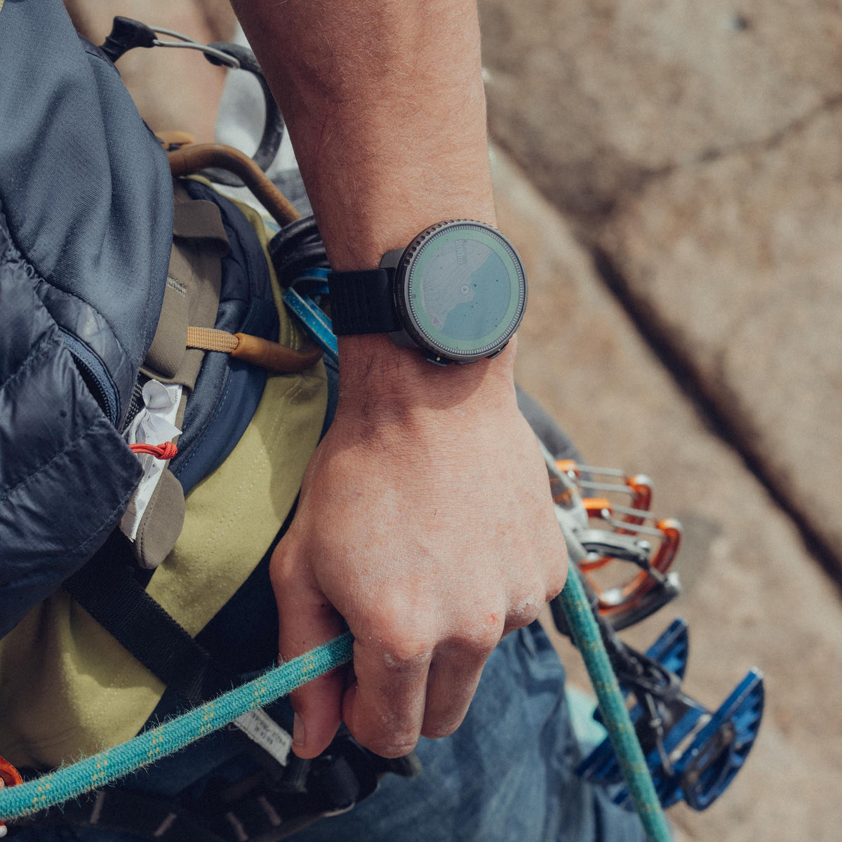 Suunto Vertical Titanium Solar Black SS050858000 action view of rock climber wearing outdoor watch with silicone strap