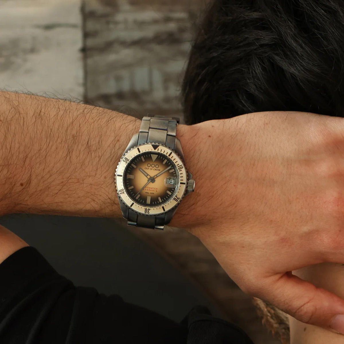 Men's distressed automatic watch with sand sunburst dial and steel link bracelet on wrist