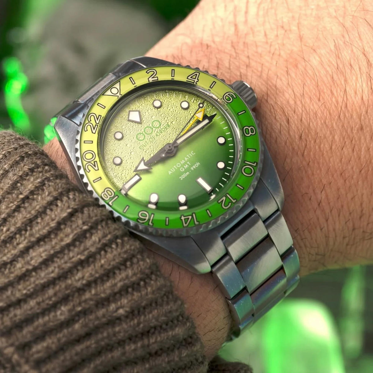 Men's stainless steel automatic GMT wristwatch with green dial and metal bracelet strap