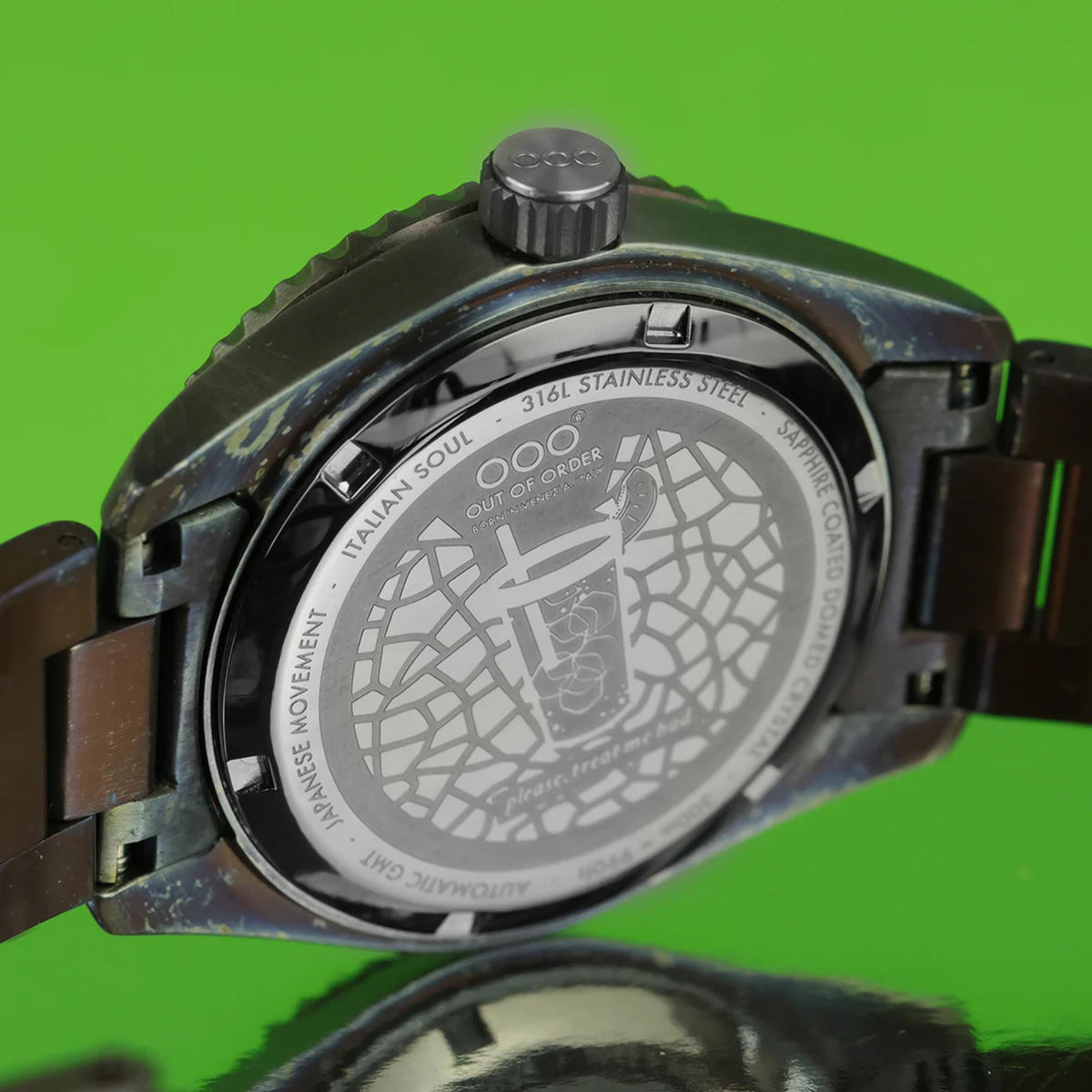 Stainless steel watch caseback with engraved pattern and text over the rear window