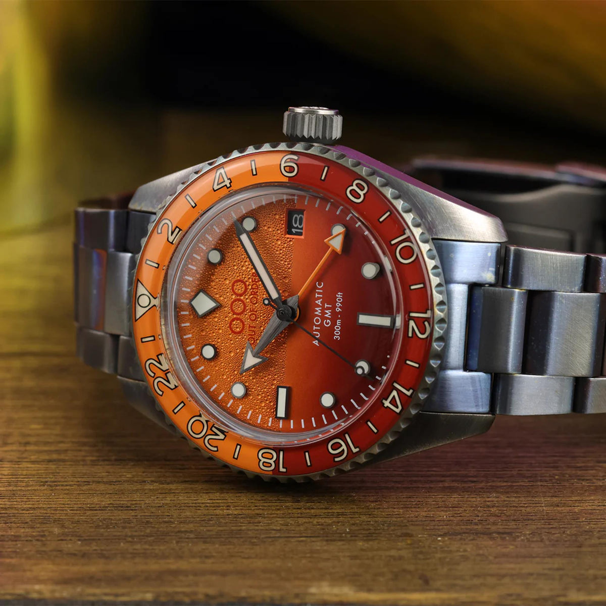 Men's automatic GMT watch with orange dial and stainless steel link strap