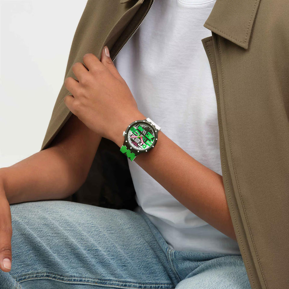 Silicone strap wristwatch, black case, white strap, colorful graphic dial on wrist