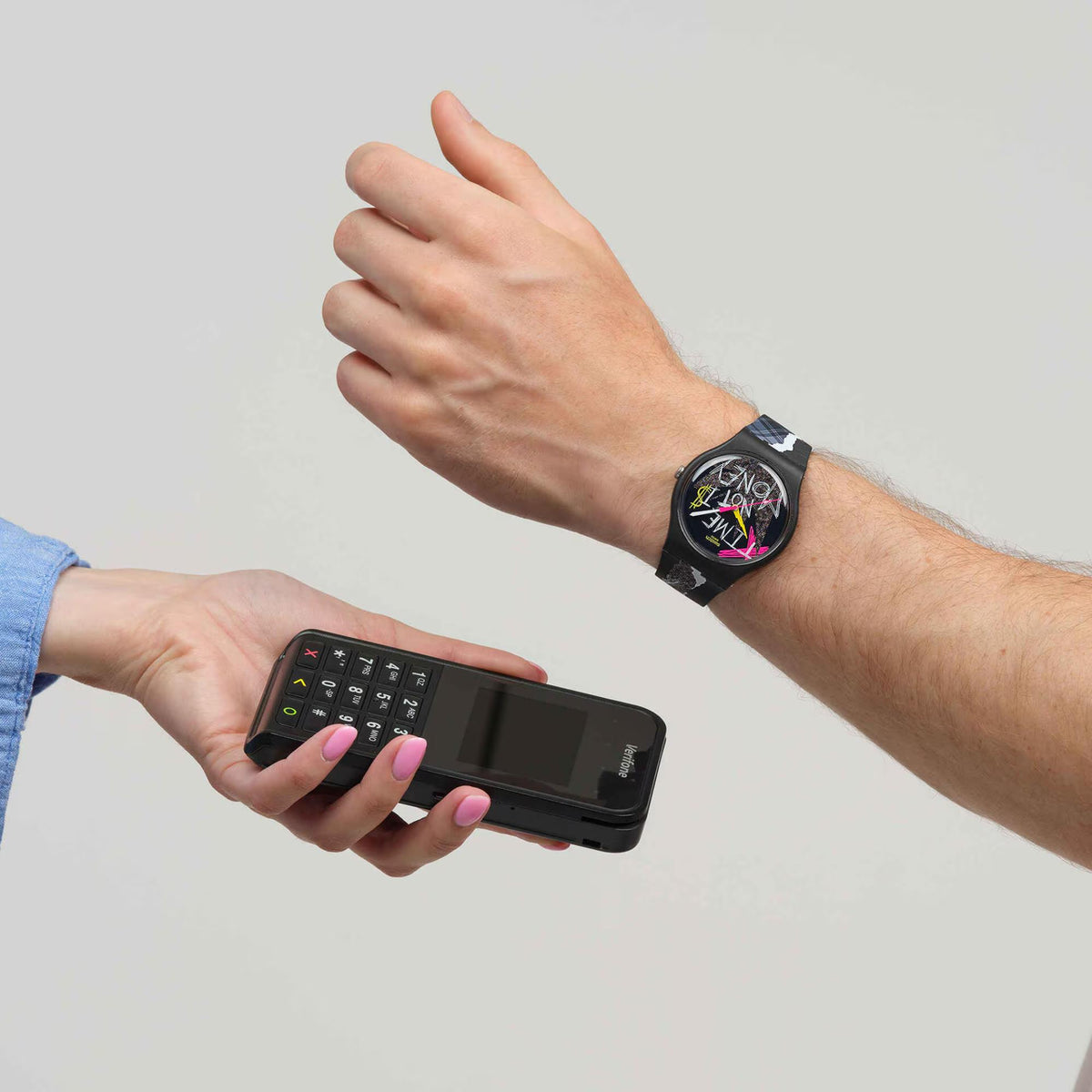 Black silicone wristwatch with abstract colorful dial on forearm