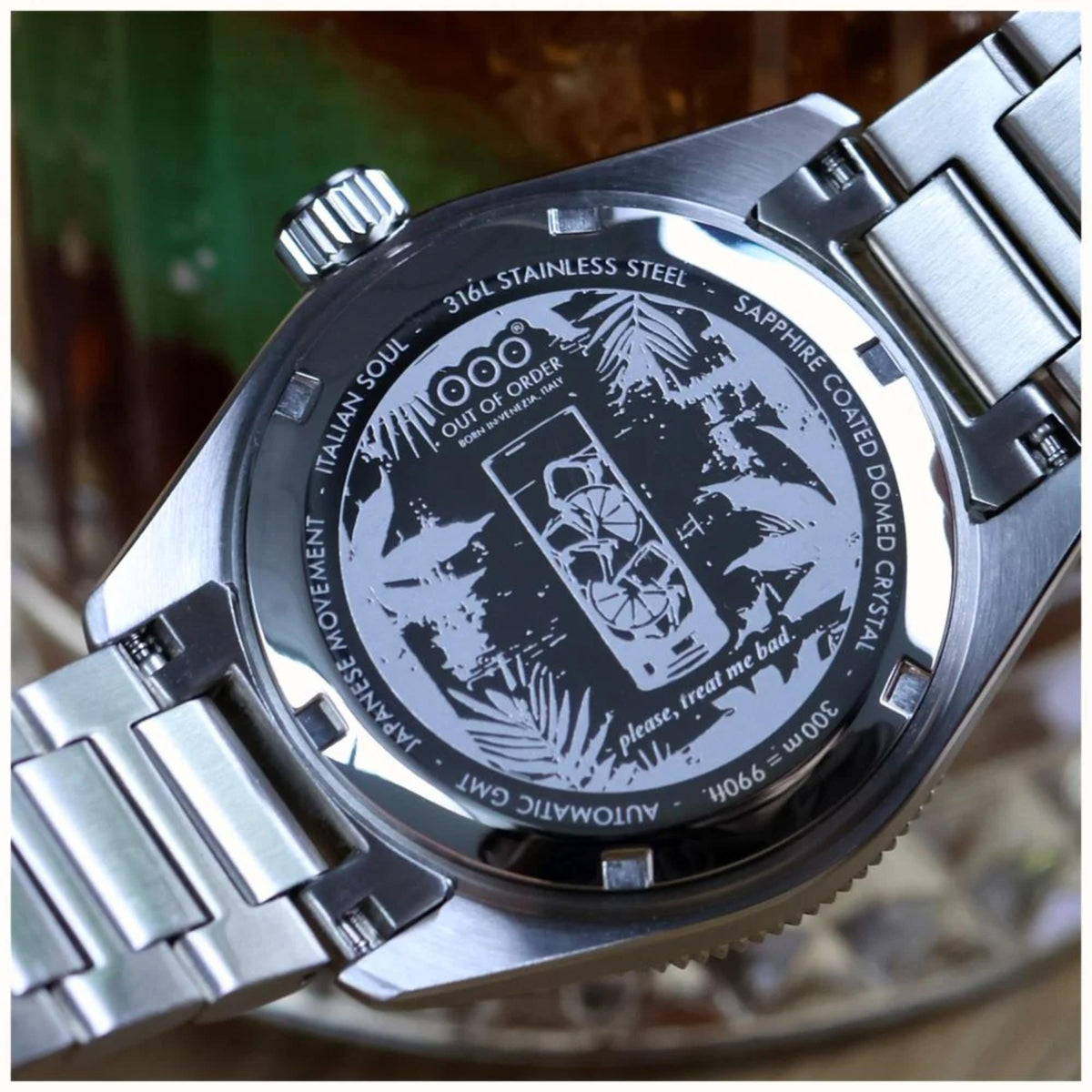 Steel watch caseback with engraved graphics, text, and sapphire crystal marking