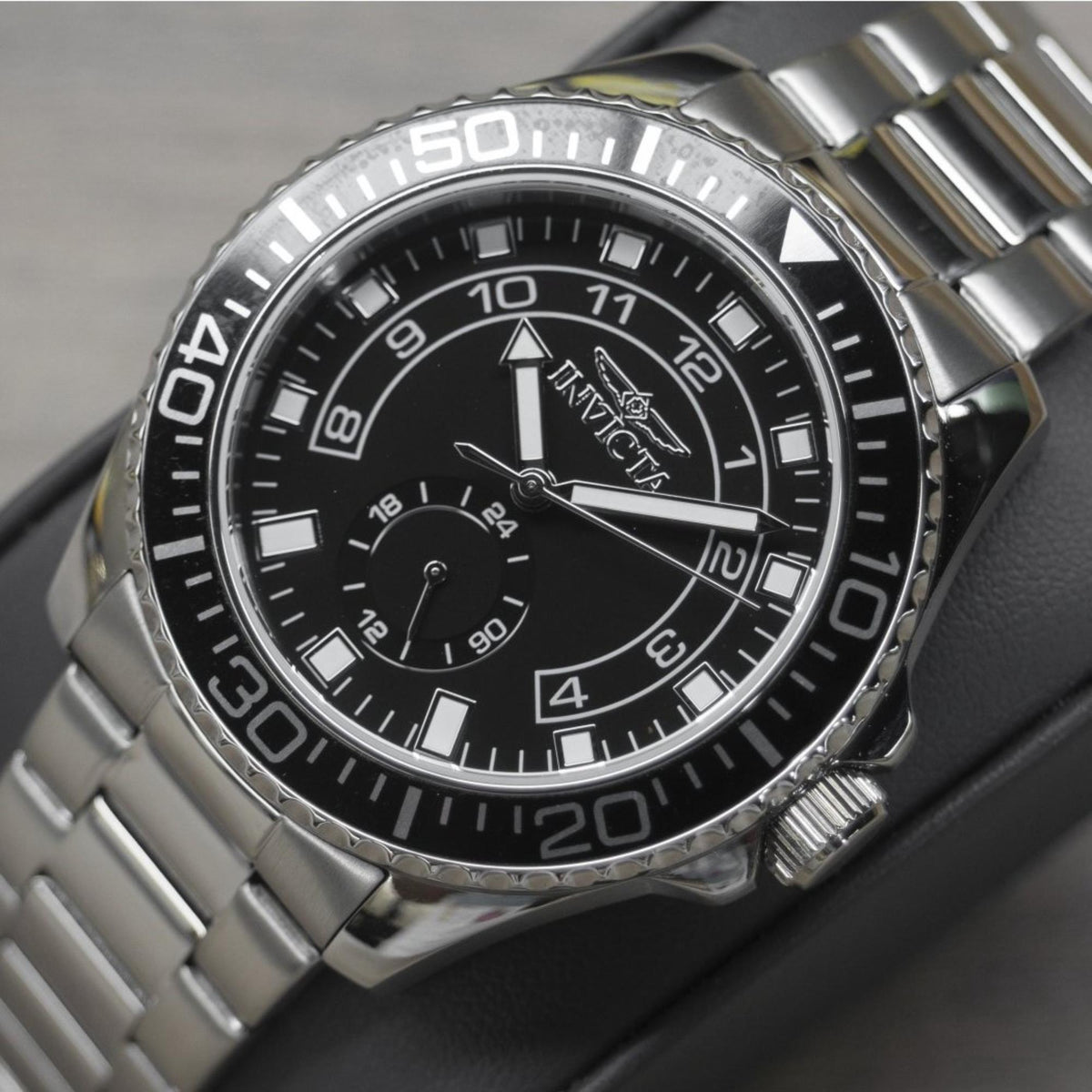 Invicta Pro Diver men's watch with black dial and steel bracelet, close-up face view