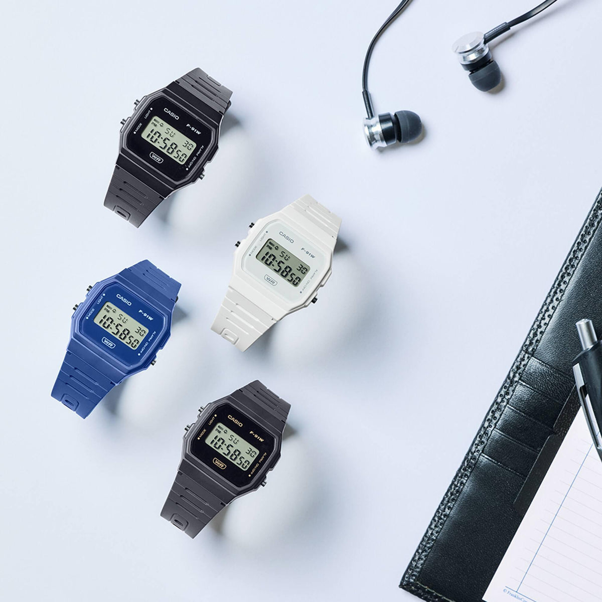 Four digital resin strap watches with LCD screens, blue, white, and dark gray bands