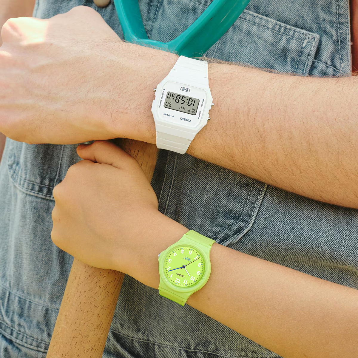 White resin strap digital quartz watch worn on wrist with visible digital screen