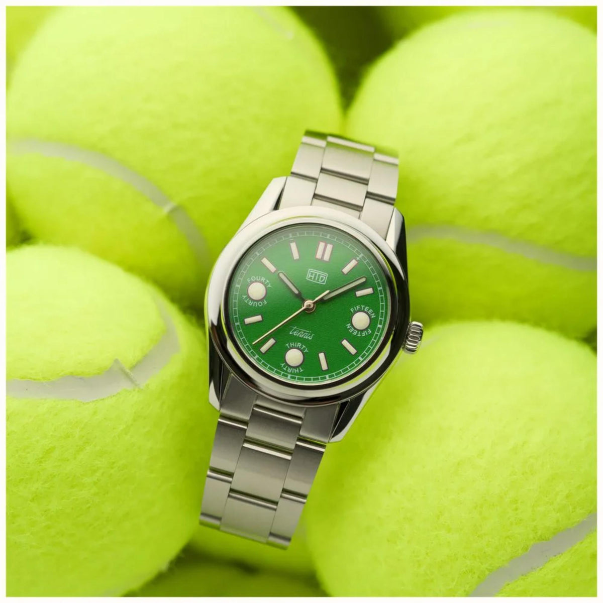 Automatic sports watch with green dial and steel bracelet, front angled view