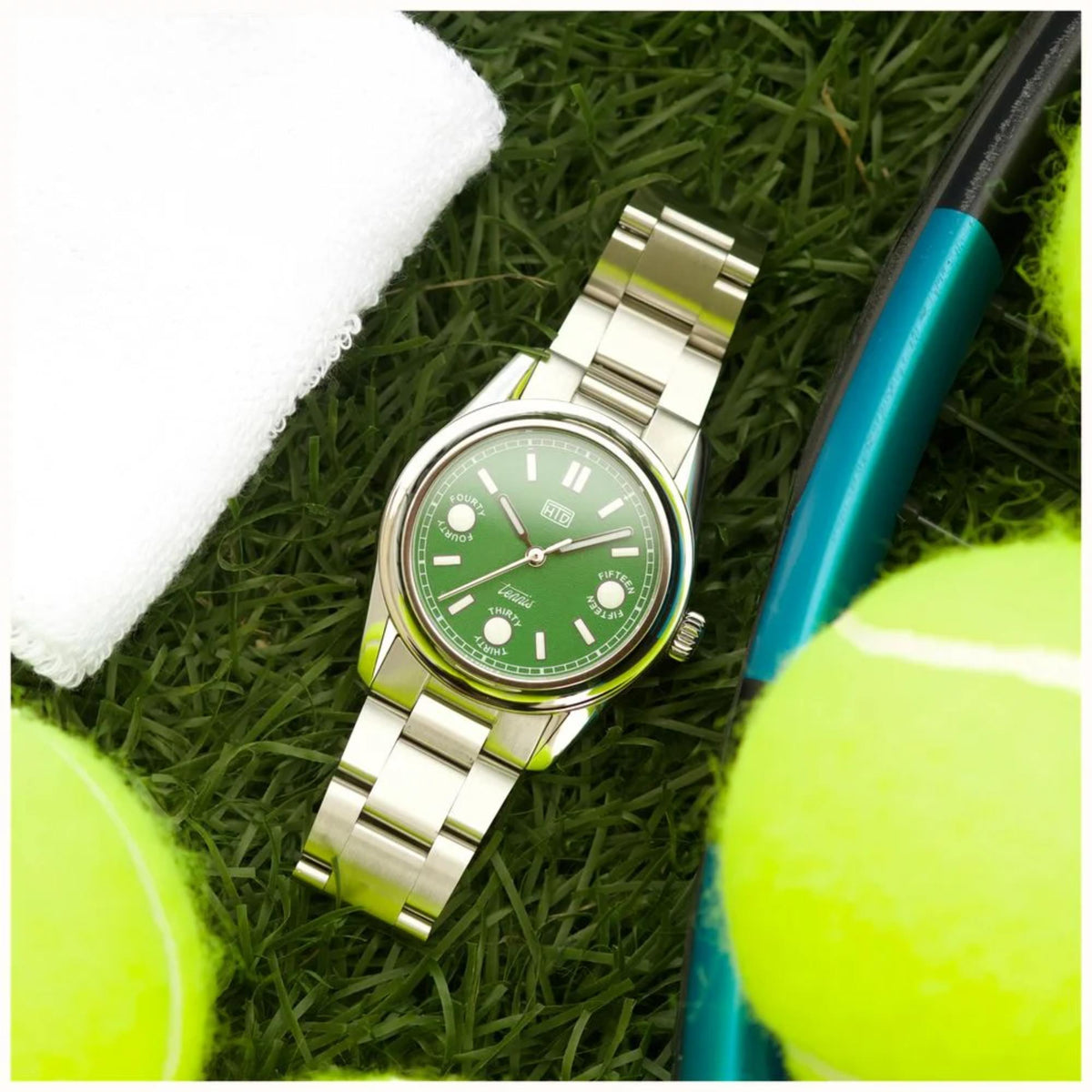 Automatic sports watch with green dial and steel bracelet, tilted front view