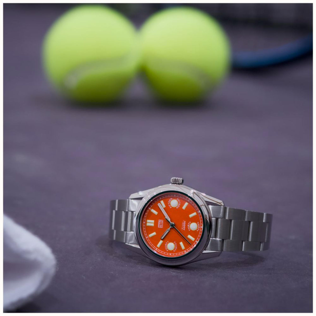 Orange dial steel sports watch with metal link bracelet and round case