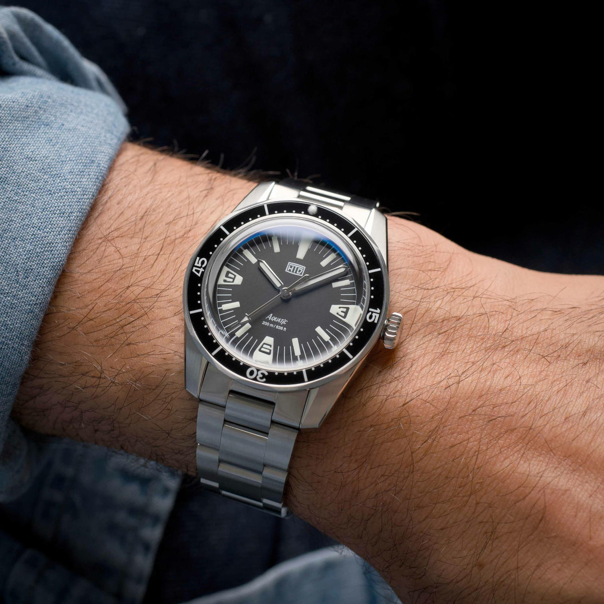 Men's steel strap watch with black dial and rotating bezel, luminous hour markers