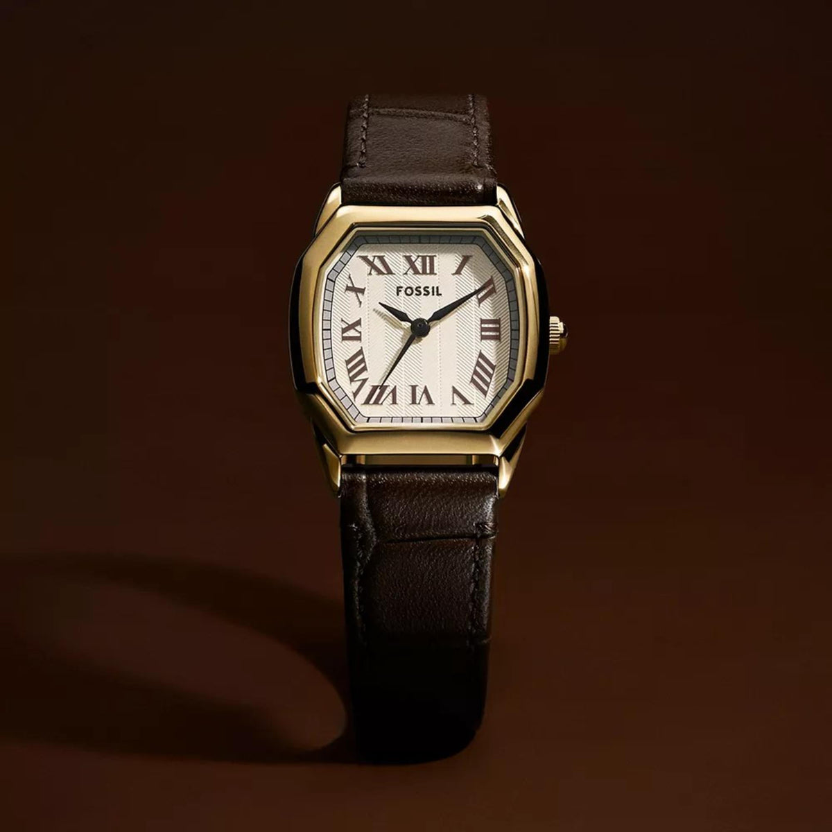 Fossil quartz watch close-up with cream dial, Roman numerals, brown leather band