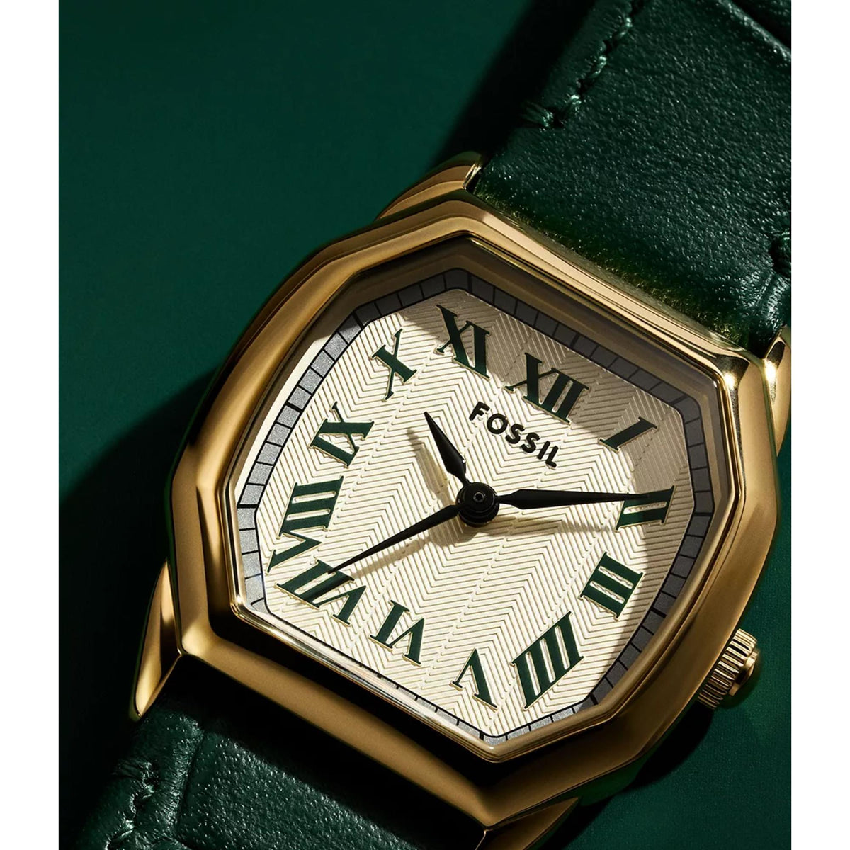 Close-up of quartz watch face with cream dial, Roman numerals, and gold-tone case