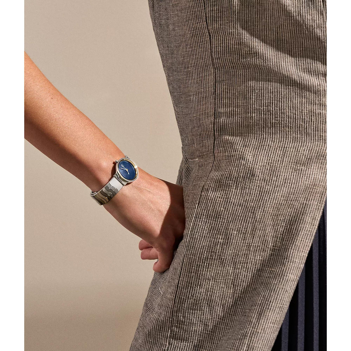 Women's steel strap quartz watch with blue dial, worn on wrist