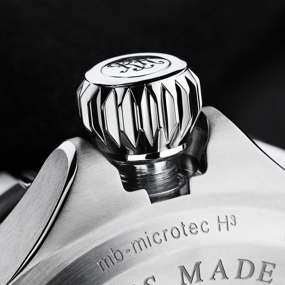 Watch crown and case detail with knurled grip and 'microtec H3' engraving