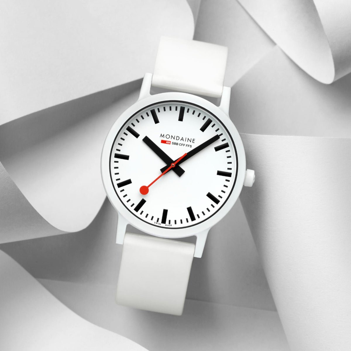 Mondaine Essence wristwatch with white dial and red accents, white silicone strap