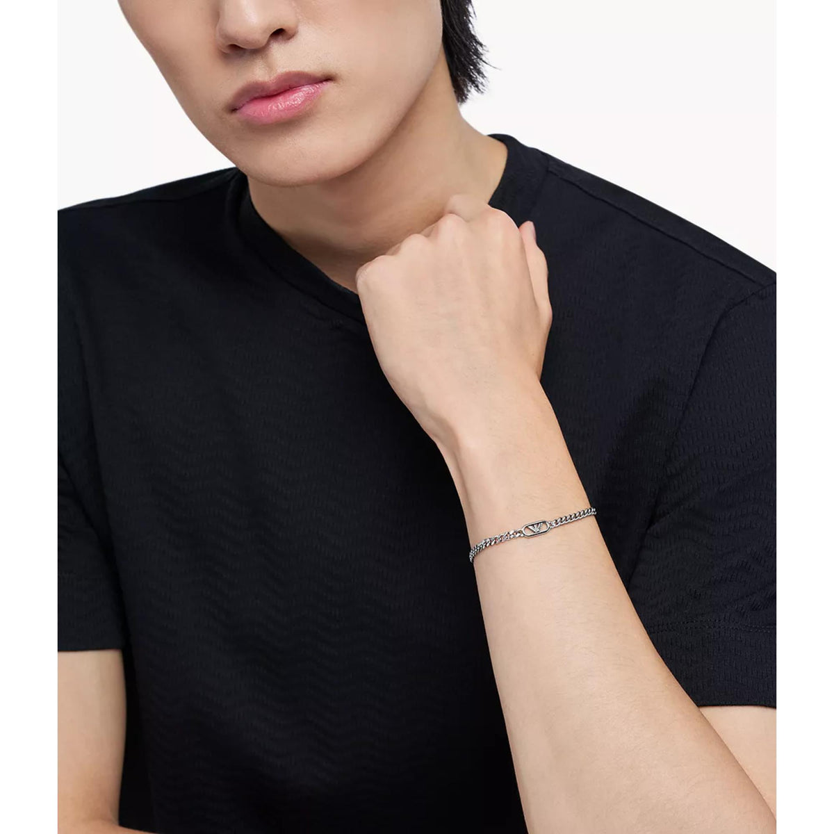 Model wearing Emporio Armani mens silver tone steel chain bracelet EGS3247040 on wrist