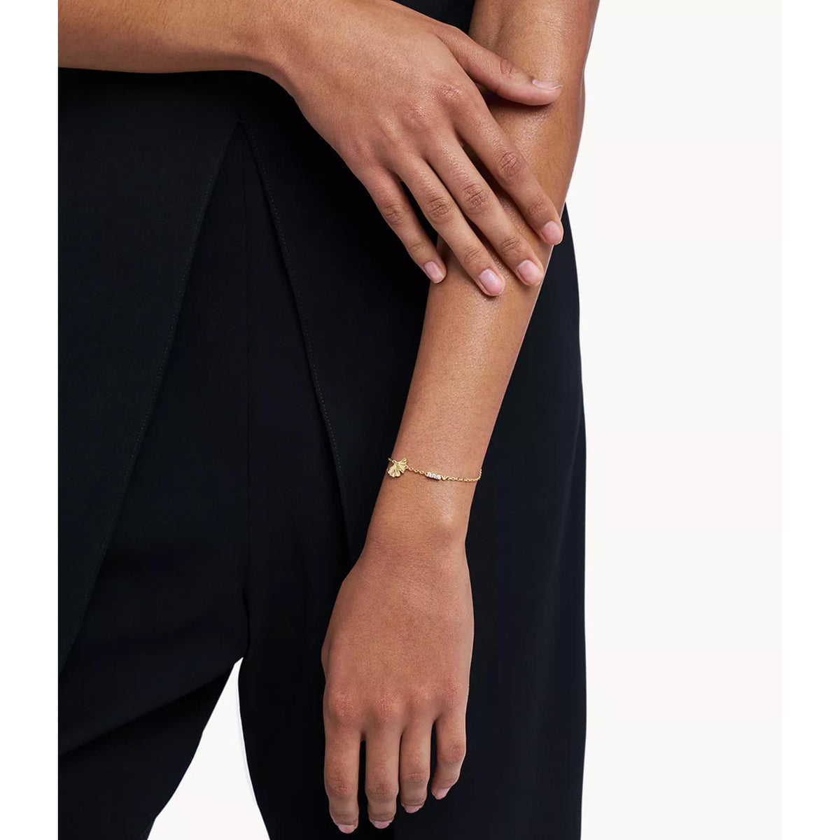 Model wearing Emporio Armani womens gold tone ID chain bracelet EGS3263710 on wrist