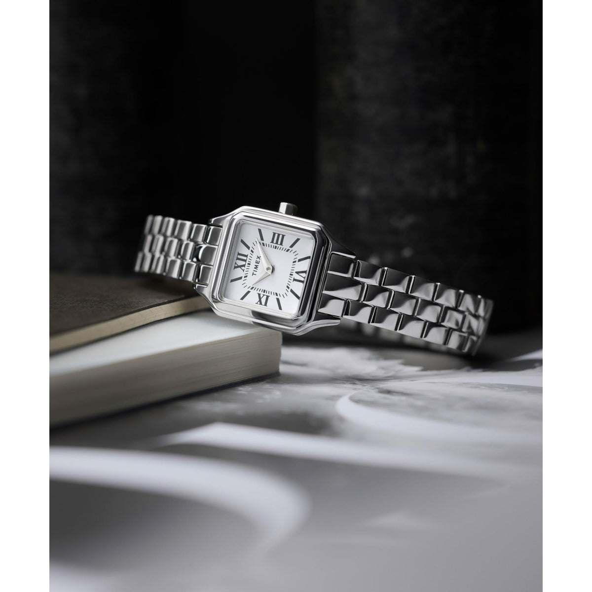 Silver ladies wristwatch with square face and steel bracelet