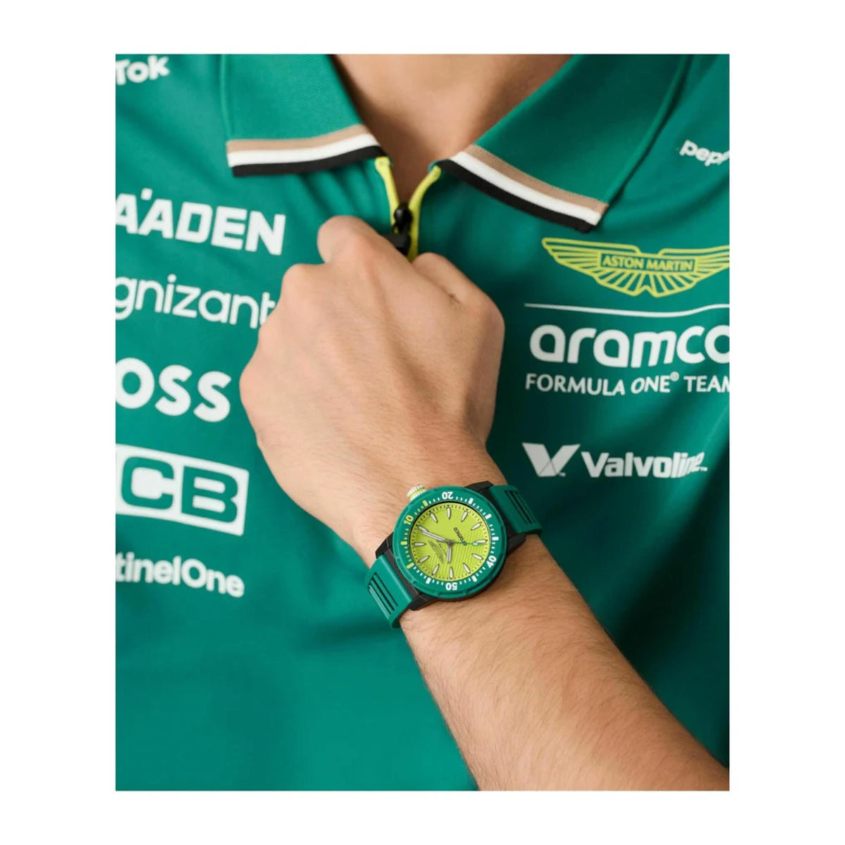 Green silicone watch on wrist with yellow-green dial and teal bezel markings.