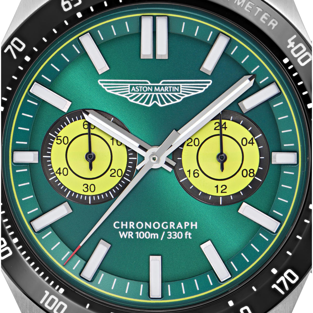 Close-up of Aston Martin MTIS1F502 green chronograph dial showing yellow subdials and winged logo detail