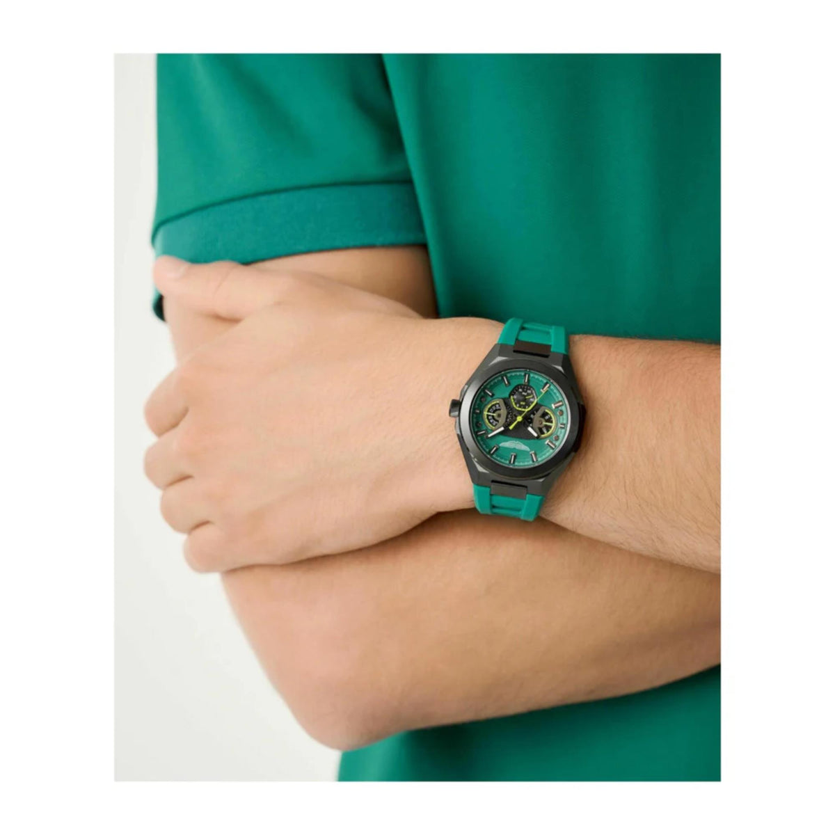 Quartz chronograph watch on wrist with green silicone strap and green dial under sleeve.