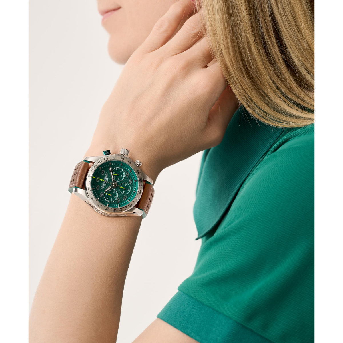 Aston Martin quartz chronograph watch with green dial and leather strap on wrist